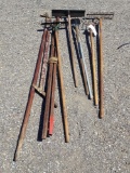 assortment of tools ? rakes, pitchforks, hoe, and more