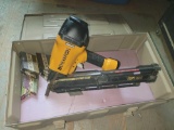 Bostitch framing nailer F33PT with metal case and box of nails