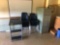 Nine stacked chairs, metal file cabinet and small desk