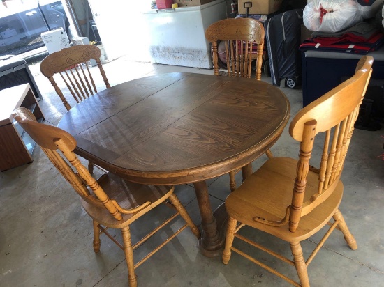 Oak dining table with 1 leaf and 4 oak chairs.