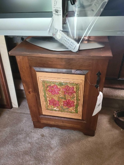 Small pine one door cupboard with floral carving on door