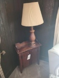 Small 2 door cabinet with wood turned lamp