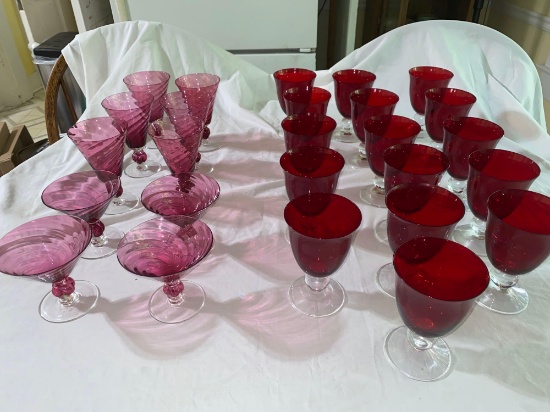 (16) Red footed glasses, (10) cranberry swirl glasses.