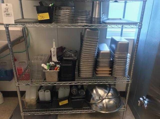 Three shelves of assorted kitchen and prep table items.