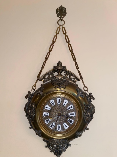 Old unmarked brass wall clock w/ porcelain Roman numerals, 26.25" tall x 13" wide.