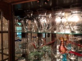 two shelves of glassware