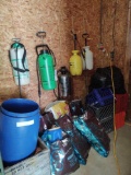 assorted sprayers, crates and bags of pine cones