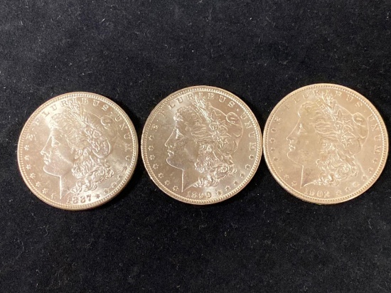 (3) Morgan silver dollars (1887, 1899-O, 1902-O). Bid times three.