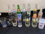 (7) Soda bottles, (7) souvenir water glasses.