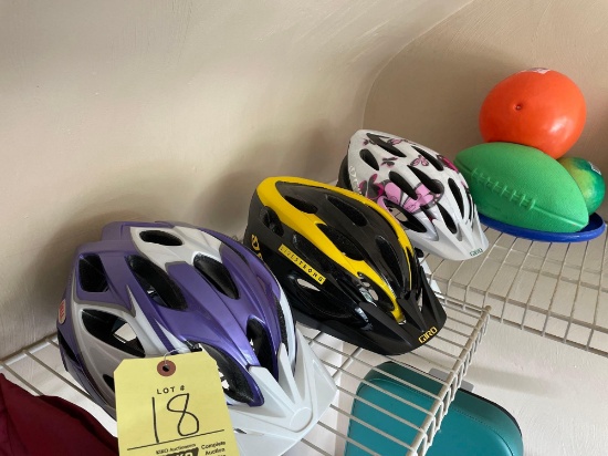 three bike helmets and balls