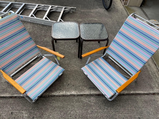 two beach chairs with two patio tables