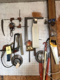 squares, saw blades and hardware on pegboard.