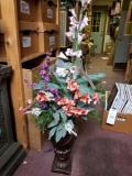 Large artificial flowers in urn