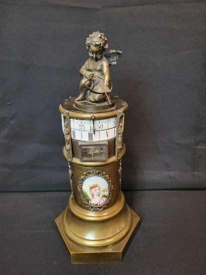 Antique Cupid cylinder style dial clock with bronze case and enameled faces and hand painted lady