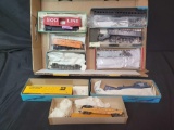 Group of HO flat cars and box car model kits, some customized