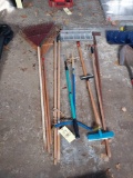 assortment of tools - rakes, shovel, edger, claw, pole saw, and more