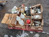 pallet of small starters, electrical components, mower blades, filters, and a rust arrestor