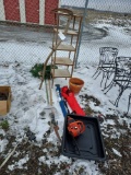 scythe, shelf, wreath, yard tools, chainsaw, outdoor chairs, and pot