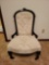 Victorian low seat upholstered chair with casters