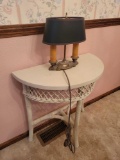 Wicker half round stand with vintage lamp