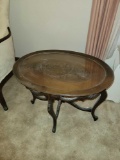 Mahogany oval table with crest carved into top and removable glass tray