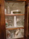 Contents of kitchen cupboards top and bottom of cabinets, china, mugs, jars, casserole dishes, and