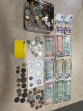 large lot of unsorted foreign coins and currency