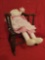 Early hip hugger rocker/potty chair, with modern rag doll