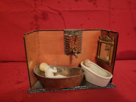 Small antique tin display with porcelain dolls