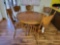 oak table with 5 press back chairs