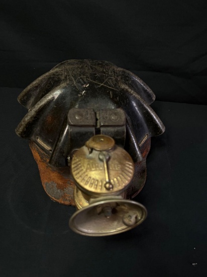 Vintage leather wrapped miner helmet with carbide light