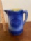 Blue and white stoneware pitcher with butterfly