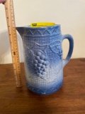 Blue and white stoneware pitcher with grapes