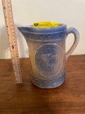 Blue and white stoneware pitcher with cows