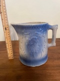 Blue and white stoneware pitcher with couple