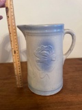 Blue and white stoneware pitcher with flower