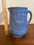 Blue and white stoneware pitcher with deer