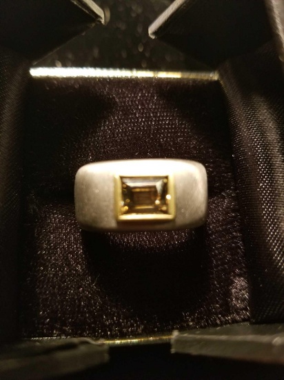 Platinum ring containing one emerald cut diamond