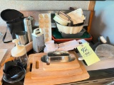 Kitchen items including cutting boards, grater, slicer, bakeware, travel mug set, misc.