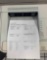 desktop laser printers with test pages printed out to verify print quality.