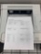 desktop laser printers with test pages printed out to verify print quality.