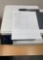 desktop laser printers with test pages printed out to verify print quality.