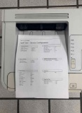 desktop laser printers with test pages printed out to verify print quality.
