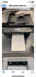 desktop laser printers with test pages printed out to verify print quality.