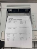 desktop laser printers with test pages printed out to verify print quality.