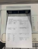 desktop laser printers with test pages printed out to verify print quality.