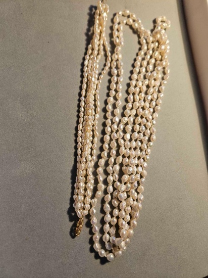Long pearl necklace with matching bracelet. Bracelet clasp is 14k yellow gold.