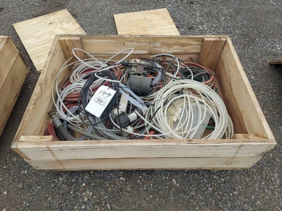 Wooden crate full of pumping hardware and air hoses.