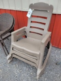 2 Outdoor plastic rocking chairs.