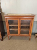 Early glass door bookcase with faux marble top insert